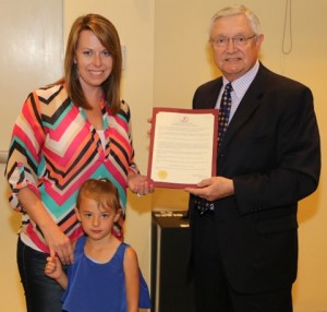 Caption: Mayor Pro Tem Michael Grannis presents Payton and Molly Herring with Promise Walk proclamation