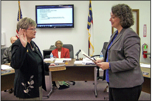 Mayor Cheryl Oliver receives her oath of office from Johnston County Clerk of Court Michelle Ball.