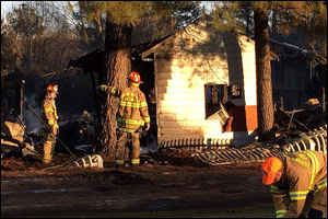 Firefighters were unable to save this large outdoor building on Davis Road but were able to save an adjacent home from sustaining serious damage Saturday afternoon. Photo by JoCoFire.com