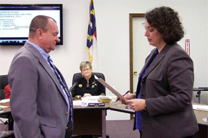 Town Councilman Tommy Holmes receives his oath of office from Johnston County Clerk of Court Michelle Ball.