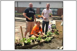 Allison Dunn (center), Exploring Careers and Exploring Biotechnology teacher, works with science teacher Zachary Finkbiner (left) and visual arts teacher Joel Fitzgerald (right) on the school’s community garden/outdoor classroom.