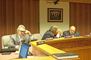 Commissioners Jeff Carver, DeVan Barbour and Chairman Tony Braswell await the start of Wednesday night’s special meeting to discuss a proposed CSX terminal in Johnston County. WTSB Photo