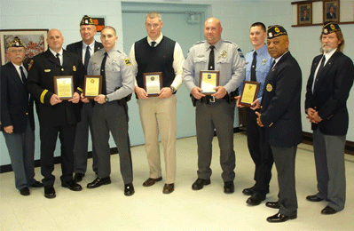 (Left to right) Post-71 Adjutant Ken Parker, Johnston County EMS of the Year Captain-Paramedic Ted Hardy, 2nd Vice commander David “Slammer” Sammons, North Carolina Highway Patrol of the Year Trooper H. D. Nazal, Johnston County Deputy Sheriff of the Year Detective Randy Ackley, Clayton Police Officer of the Year Jeff Young, Clayton Fireman of the Year Daryle Harris, Post-71 Commander Devell “Bull” Durham, and Post-71 1st Vice commander Eugene “Beanie” Eckerson. 