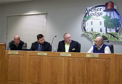  (left to right) Archer Lodge Councilman Clyde Castleberry, Councilman J. Mark Jackson, and Mayor Michael Gordon listen as town attorney Chip Hewett discusses the process to place an Alcohol Referendum before town residents in November. WTSB Photo  