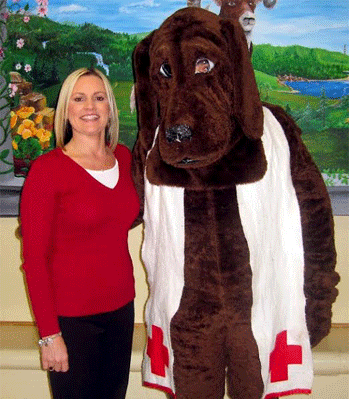 (Left to right) Cleveland Middle Principal Jenna Sauls Hairr, Principal stands with American Red Cross Dog at third annual Cleveland Middle School blood drive.