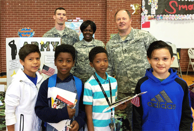 Selma Elementary students enjoying a Career and College Promise Fair on Feb. 26, on the front row (from left) are Raul Vargas Esquivias, Devyn Grant, Lorenzo Smith, and Johan Vargas Vieyra. Behind them are special guests, (from left) Retired Master Sergeant Jeffery Reason, Staff Sergeant Stephanie Parker, and Specialist Dominick Montgomery.