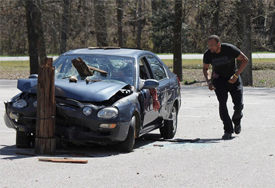 North Johnston Coach Jason Wilson is the first on the scene during Tuesday’s mock crash held at the school.