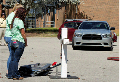 Alexis Thrash, North Johnston High School Chapter President of JOCO Teen Drivers, stands in front of the roadside memorial at the VIP for a VIP mock crash on Tuesday, March 15.