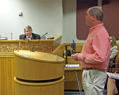  Jeremy Norris, the owner of Broadslab Distiller in Meadow, speaks to Johnston County Commissioners on Monday. Norris wants a countywide alcohol sales referendum placed on the November 2016 ballot to allow voters to decide on beer and wine sales in all unincorporated areas. JoCoReport.com Photo