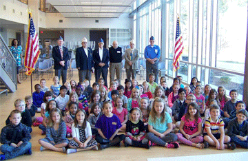  A group of Johnston County veterans distributed US flags to first graders at Neuse Charter, a private school, on March 9th. The group says they were not allowed to hand out the American flags to students in Johnston County Public Schools. JoCoReport.com Photo