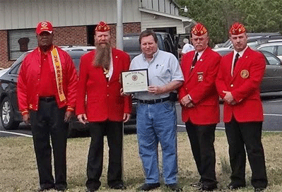 (Left to right) Marine John Whitley, Commandant Timothy Daniel, accepting the award Manager Darrell Robbins, Adjutant/Paymaster Ken Parker, and Public Relations Officer Lewis W. Rice III.