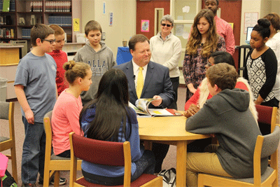 (From left) Adam Smith, Michael Synoracki, Savannah Hicks, Alexander Halloran, Tania Gomez, Dr. Ross Renfrow, Kristin Williams, Charley Baun, Andre Smith, Trinity Holder, Parker Whitley, Amya Smaw, and Sheila Singleton read together during Read Across America Week. 