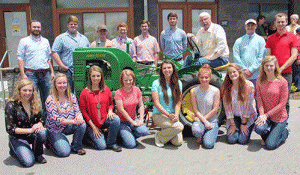 Agriculture Commissioner Steve Troxler, back row, third from right, meets with 16 of the 27 recipients of the 2016 N.C. State Fair Youth Livestock Scholarships at the Got to Be NC Festival. 