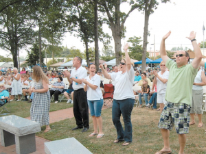 Benson’s Singing Grove will be filled with enthusiastic crowds this weekend for the town’s 96th State Annual Singing Convention, which kicks off Friday evening with a special ‘Singspiration’ concert. Pictured, a particularly lively crowd from a past event enjoys the gospel music. Photo and story courtesy The Dunn Daily Record