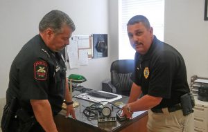 Four Oaks Police Chief Stephen Anderson examines a radar unit with Officer B.L. Flowers. The used radar unit was loaned to Four Oaks Police this week from the Princeton Police Department but because no Four Oaks officers are certified to use the unit, the department cannot issue speeding tickets based on the radar readings. JoCoReport.com Photo