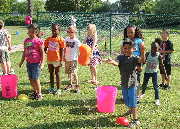 Pictured waiting for their turn at the Sponge Toss game from Laura Hansen's first grade class are (from left) Ingrid Martinez-Franco, Conita Thomas, Devan Pace, Reace Soronen, Yair Barrios (shown tossing the sponge), Karla Lorenzo, Nasiyaah Barnes and Darey Rivera.