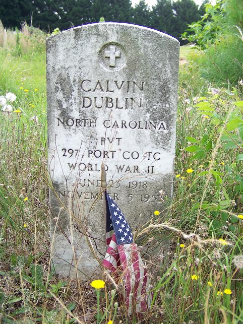 A tattered American flag is overrun with weeds at the unkempt grave of World War II Veteran Calvin Dublin who was buried in 1952 in what is now an abandoned cemetery in Selma. An estimated 140 graves are located on the acre tract of land. About 60 of the graves are marked only with crosses bearing no names. Another 30 graves markers have been vandalized. Many others are leaning and in need of repair. JoCoReport.com Photo