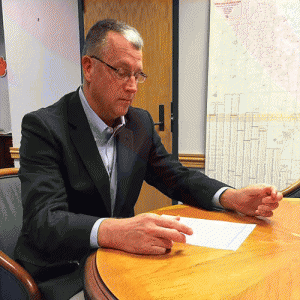  Johnston County Manager Rick Hester reviews paperwork implementing an increase in the garbage decal fee from $65 to $100 effective this month.   