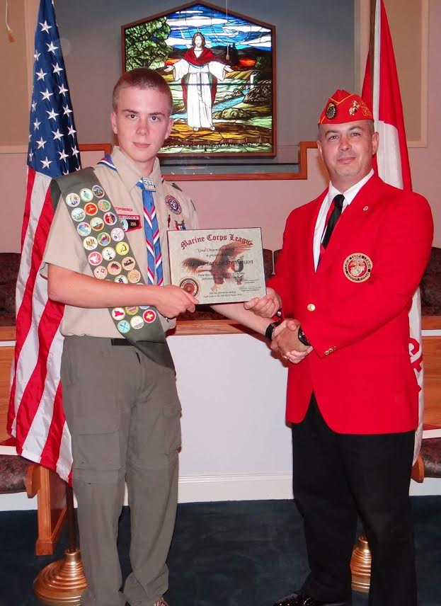 (Left to right) Jesse Stephenson from Boy Scout Troop #421 in Archer Lodge receives the Eagle Scout Good Citizenship Award from Lewis Rice III of the Johnston County Marine Corps League Carry-On Detachment #1236 during a special ceremony on Sunday at Amelia Christian Church in Clayton. 