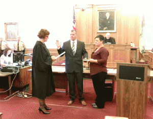 Newly-elected County Commissioner Larry Wood takes his Oath of Office from District Court Judge Caron Stewart.  JoCoReport.com Photo