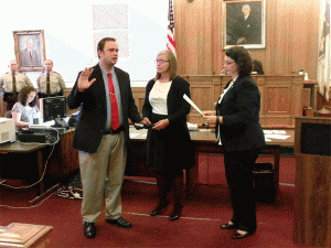 Ronald Johnson, a Smithfield police officer, receives his Oath of Office for the Johnston County School Board from Clerk of Court Michelle Ball. Johnson’s wife hold the Bible. JoCoReport.com Photo