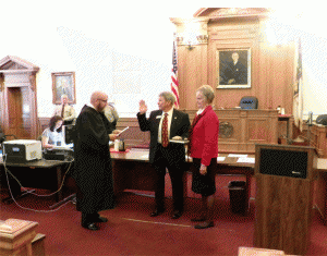 Commissioner Ted Godwin receives his Oath of Office from Resident Superior Court Judge Thomas Lock. Godwin was elected in November to his second term.  JoCoReport.com Photo