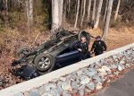 Vehicle Overturns After Going Over Retaining Wall